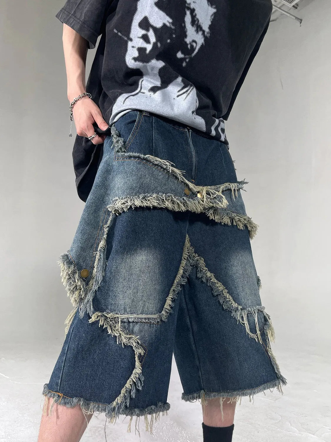 Blue men's denim shorts with frayed hem and five-pointed star decoration in loose retro style