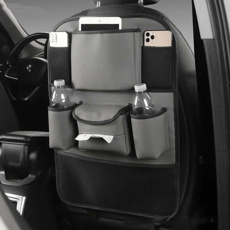 Genuine leather car seat back storage bag shown in grey, suspended behind a car headrest.