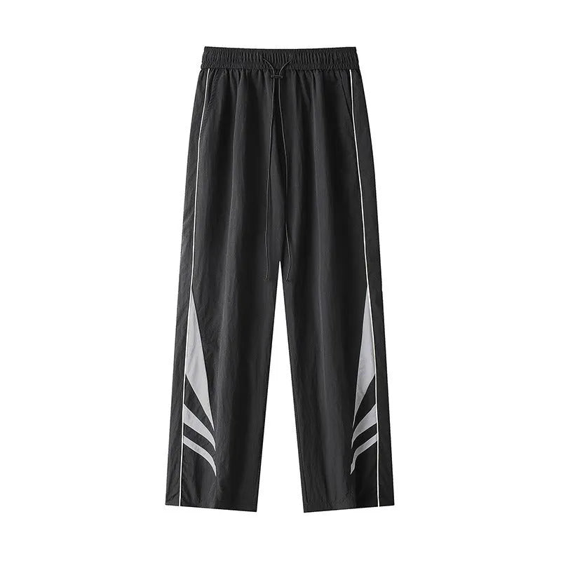 Men's straight leg summer sports trousers in grey, showing loose fit and button fly.