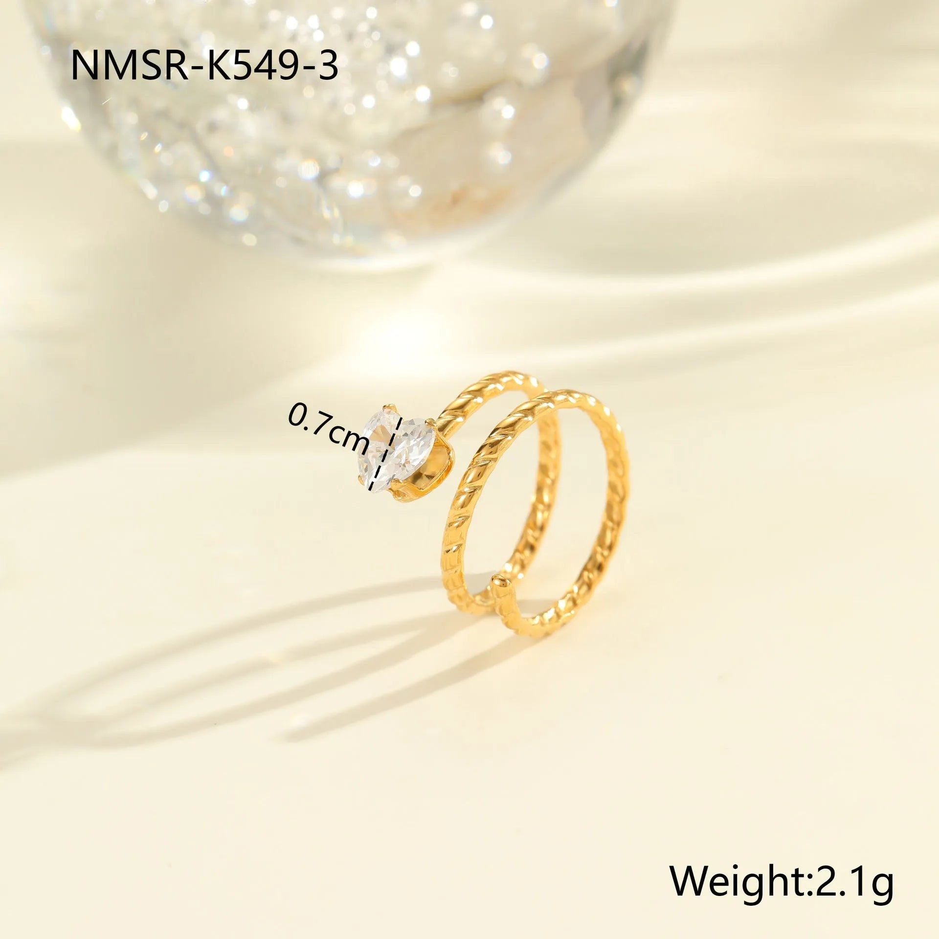 Gold-plated geometric stainless steel ring with inlaid zircon stones on a white background.