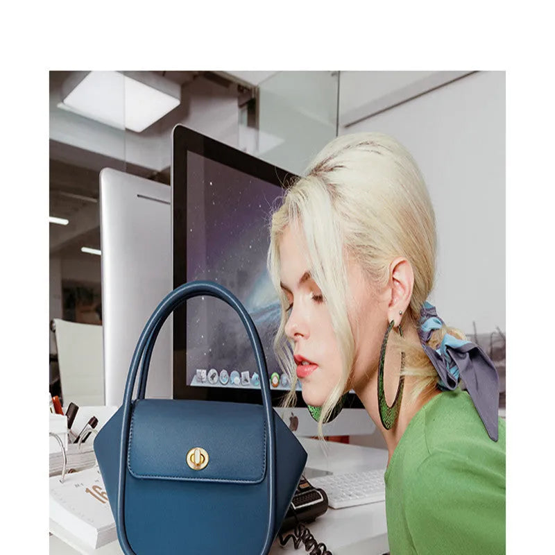Leather wing bag with latch closure and buckle detailing in cow leather with cross-body strap