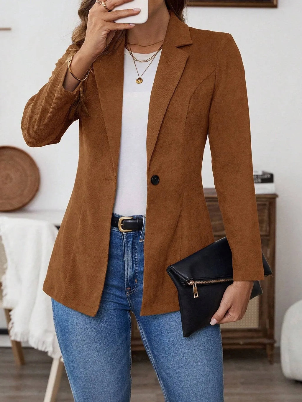 Brown single-breasted leisure suit coat with lapel collar and long sleeves on hanger