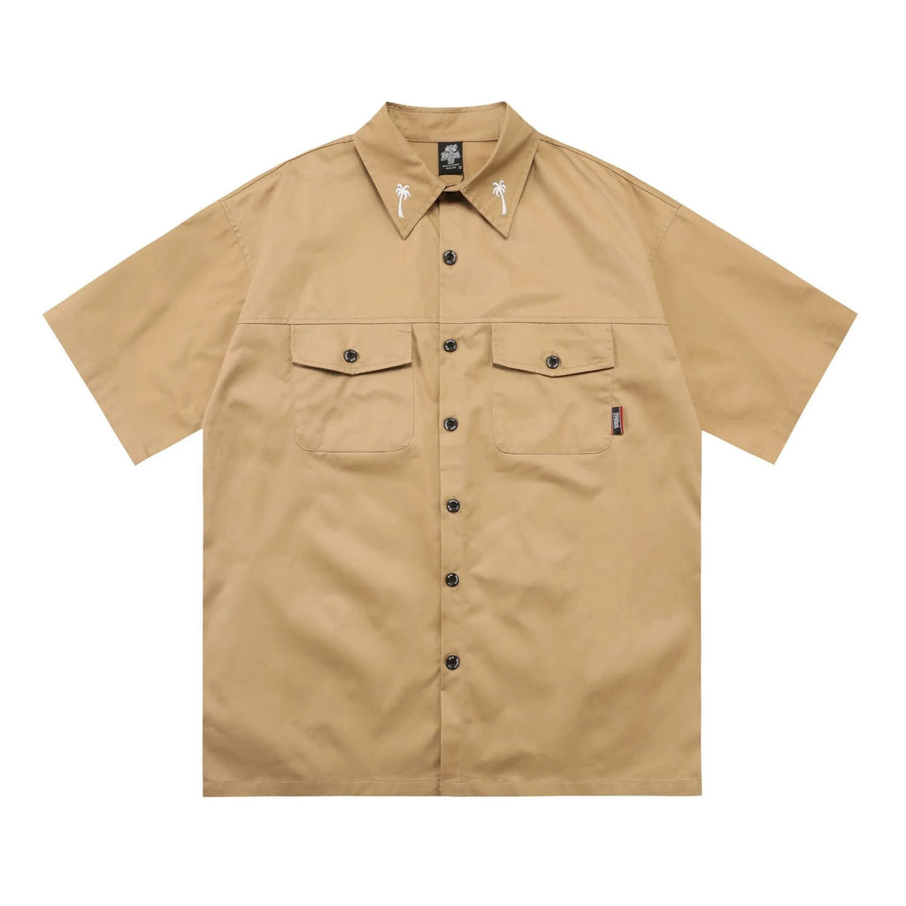 Men's black loose fit cotton blend pocket shirt with half sleeves and embroidered detail on a hanger.