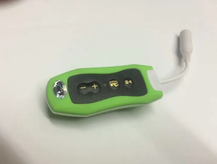 Compact black Bluetooth MP3 player with attached earphones, shown next to a USB cable.