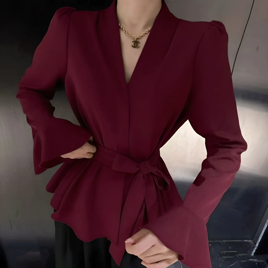 Women's black long sleeve shirt with irregular French collar, front tie, and bell sleeves