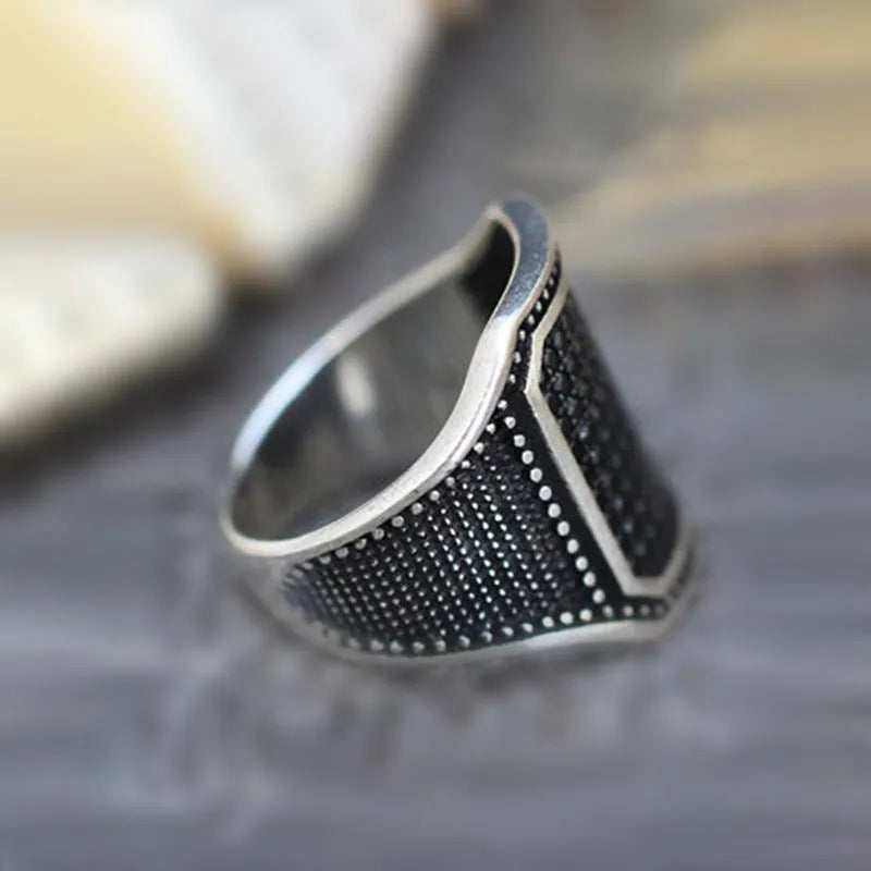 Black alloy ring with copper inlay and zircon stones showing gothic design details