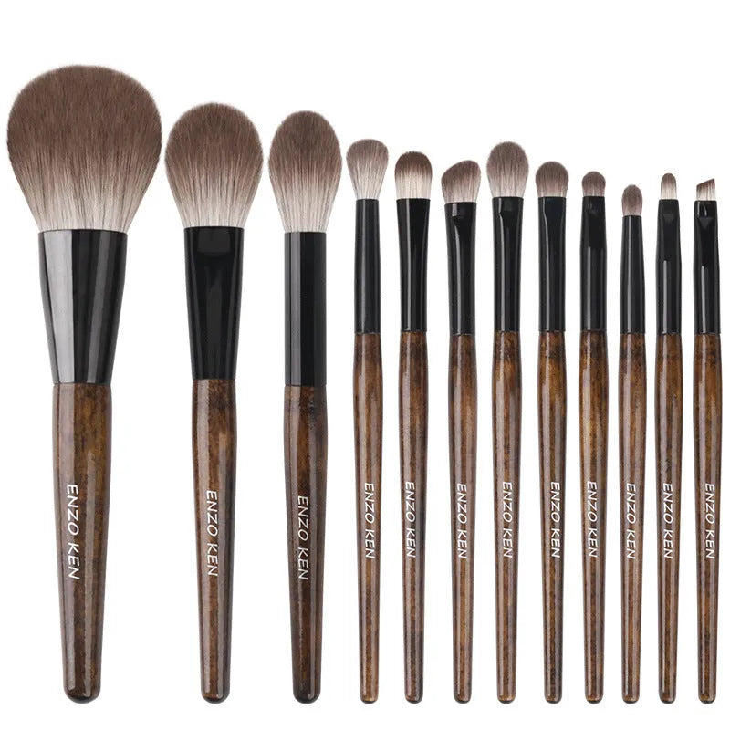 12-piece makeup brush set with wooden handles and a black PU storage pouch laid out.