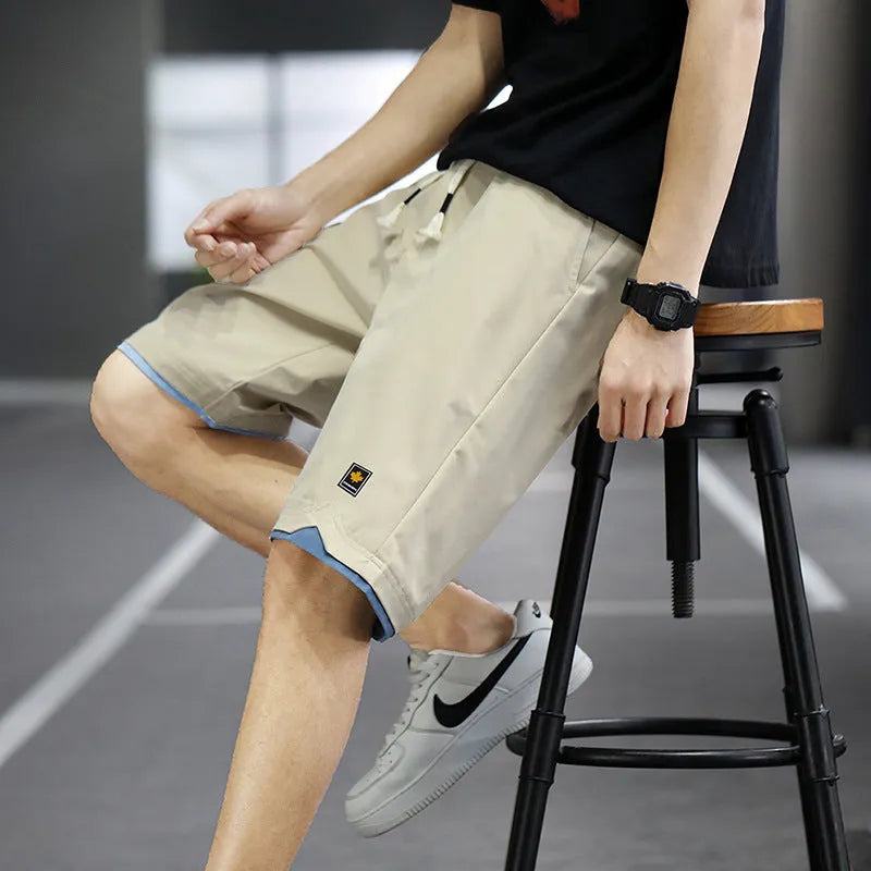 Men's loose-fit casual shorts in khaki colour with elastic waistband, shown on a neutral background.