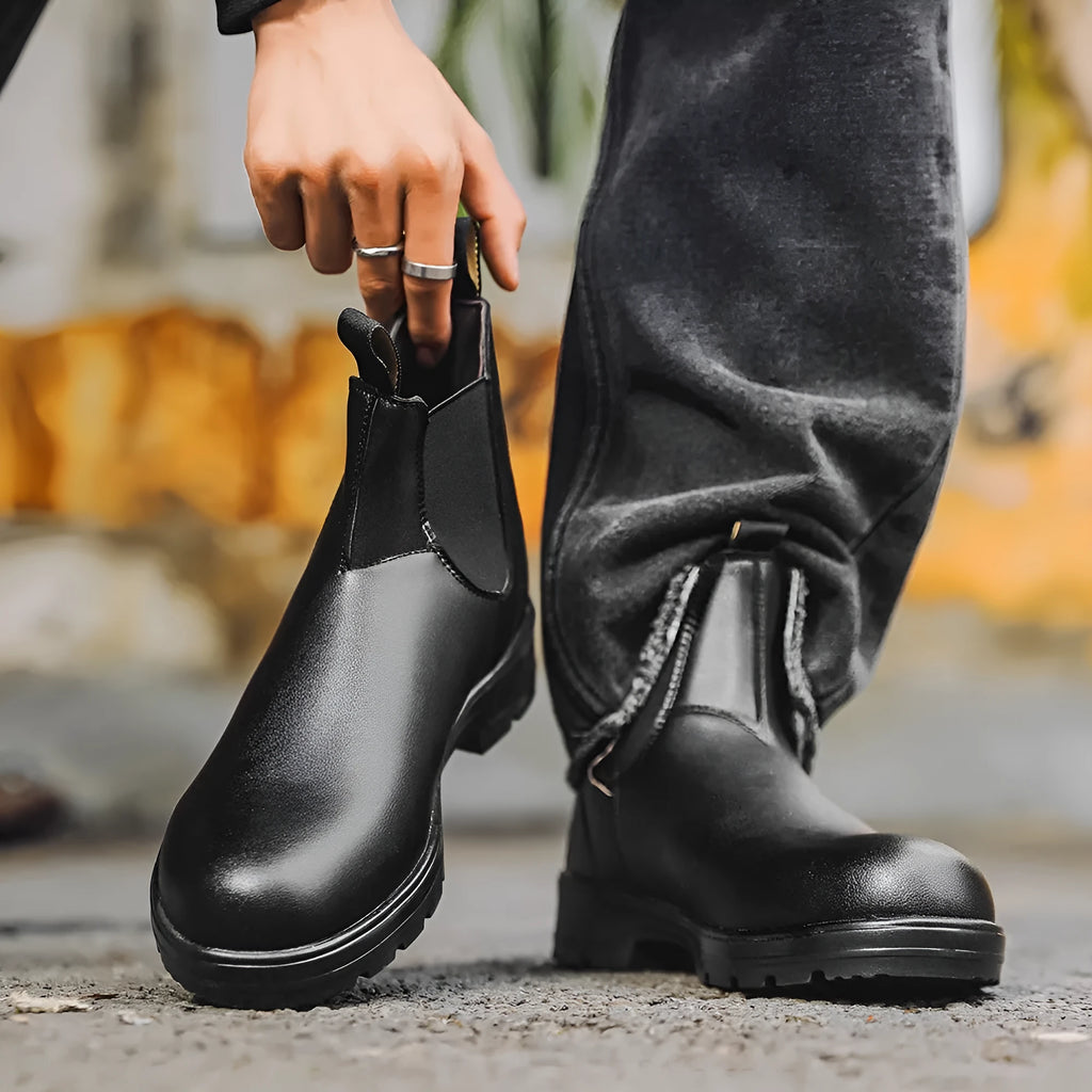 Vintage brown unisex Chelsea boot with frosted PU upper and round toe on a wooden surface.