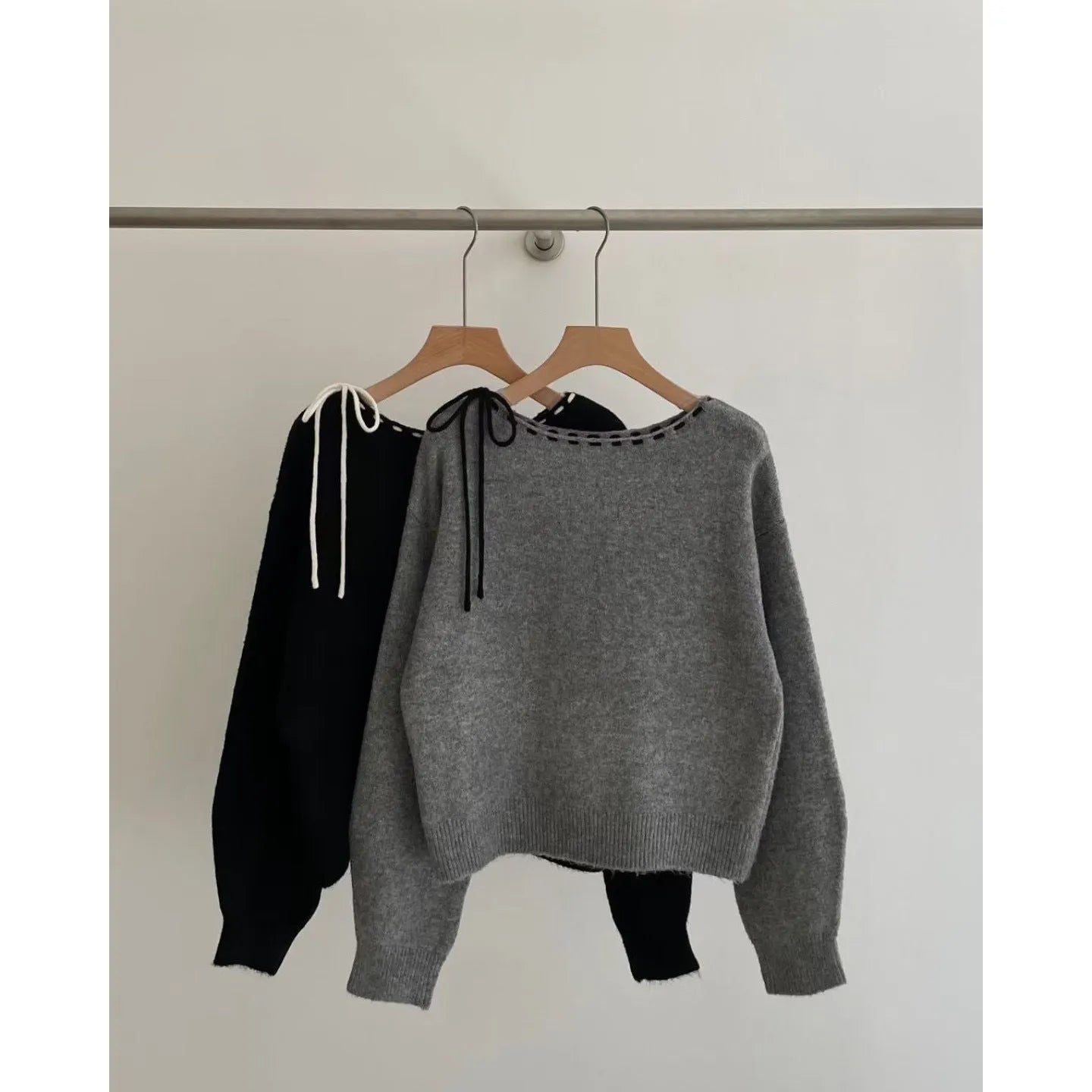Grey loose-fitting women's knitwear pullover on a hanger