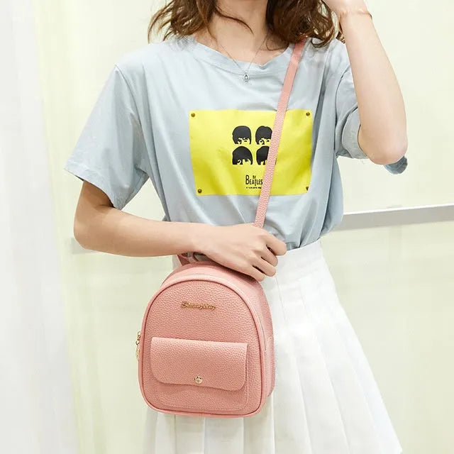 Solid colour PU leather women's small shoulder backpack with zipper, shown in available colours.