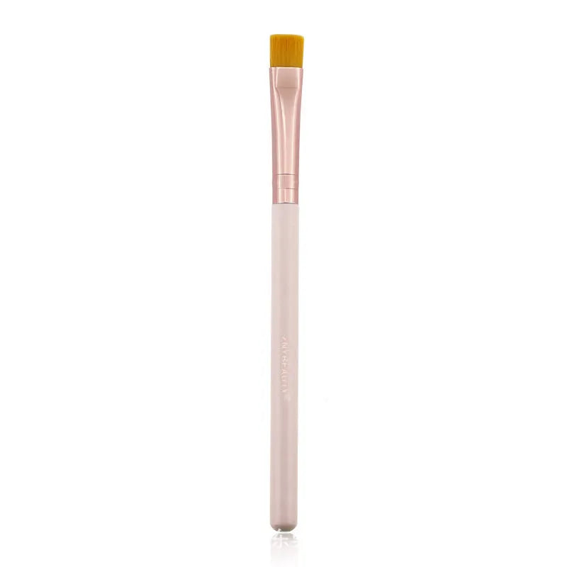 26 pink makeup brushes with wood handles arranged in a PU travel pouch.