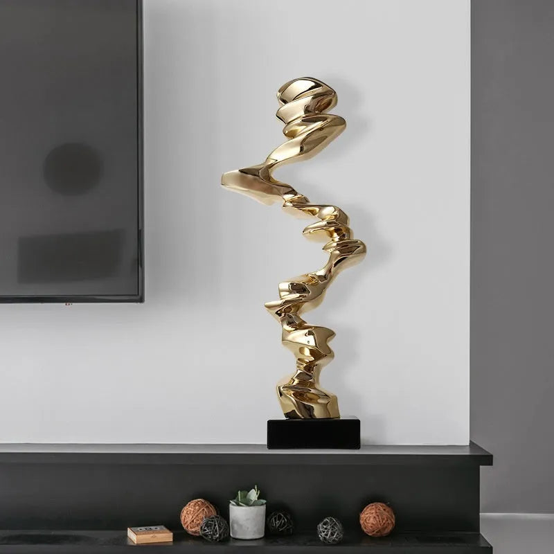 Modern abstract decorative ornament made from natural resin in a choice of gold, silver, or blue.
