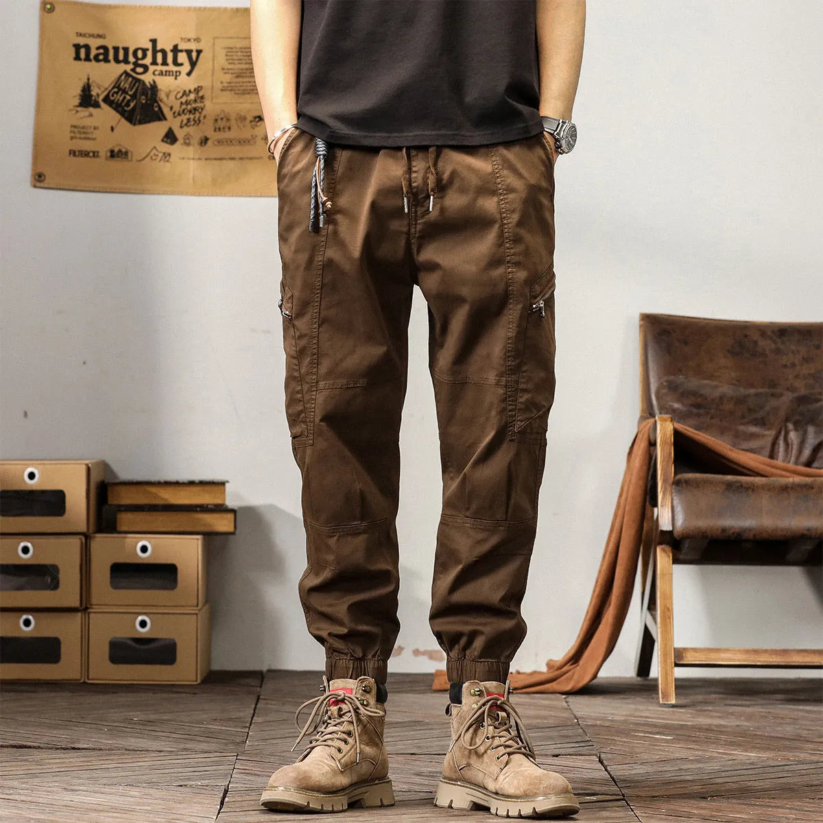 Men's khaki cotton harem pants with tapered ankle bands and a mid-waist zip fly.
