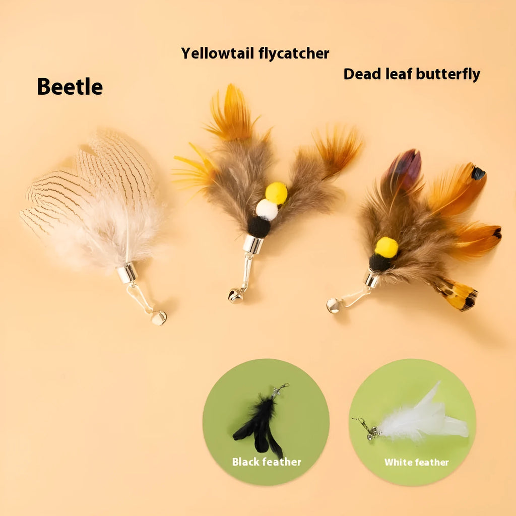 Three steel wire cat toys with small coloured flying insect heads on a table.