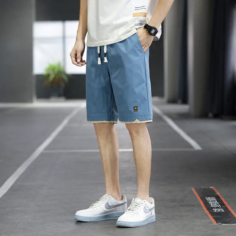 Men's loose-fit casual shorts in khaki colour with elastic waistband, shown on a neutral background.