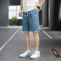Men's loose-fit casual shorts in khaki colour with elastic waistband, shown on a neutral background.