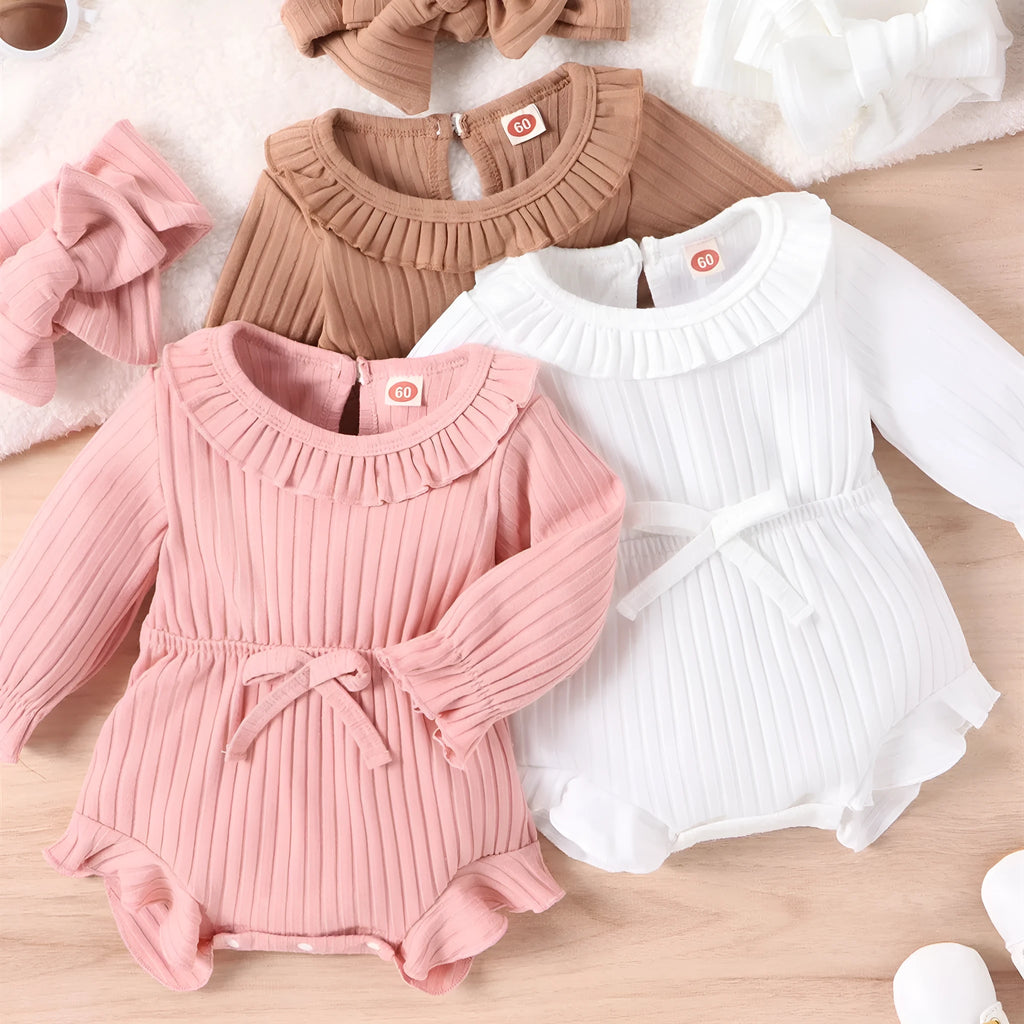 Baby girl wearing long sleeve cotton striped romper and headscarf in white