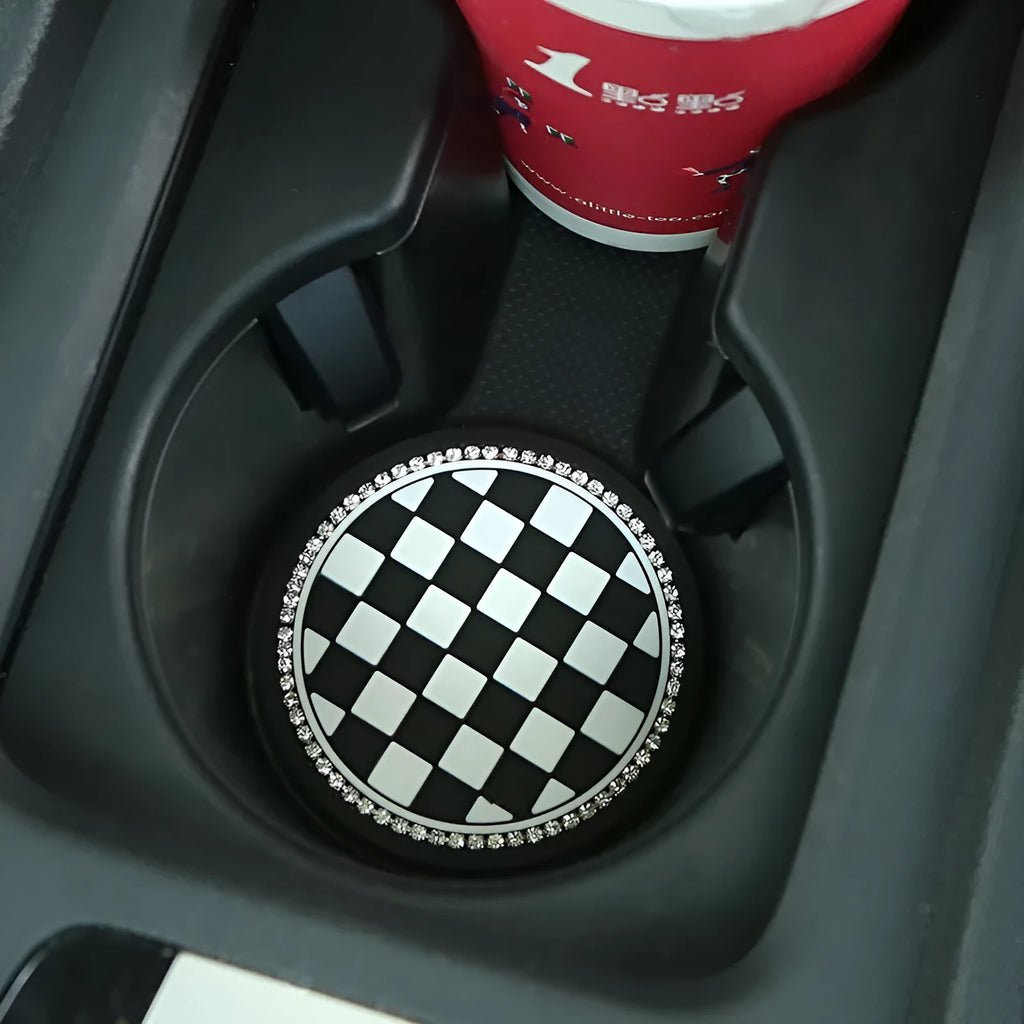 Black and white checkerboard PVC car cup holder mat inserted into vehicle centre console slot