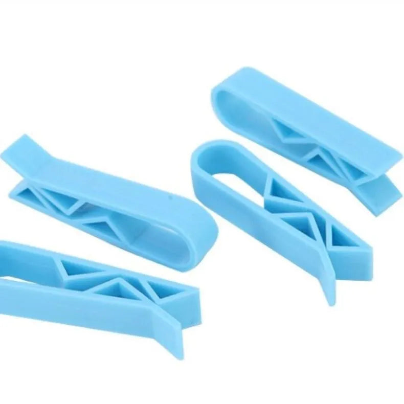 White PP plastic garbage bag fixing clip holding a black bin liner to a trash can rim.