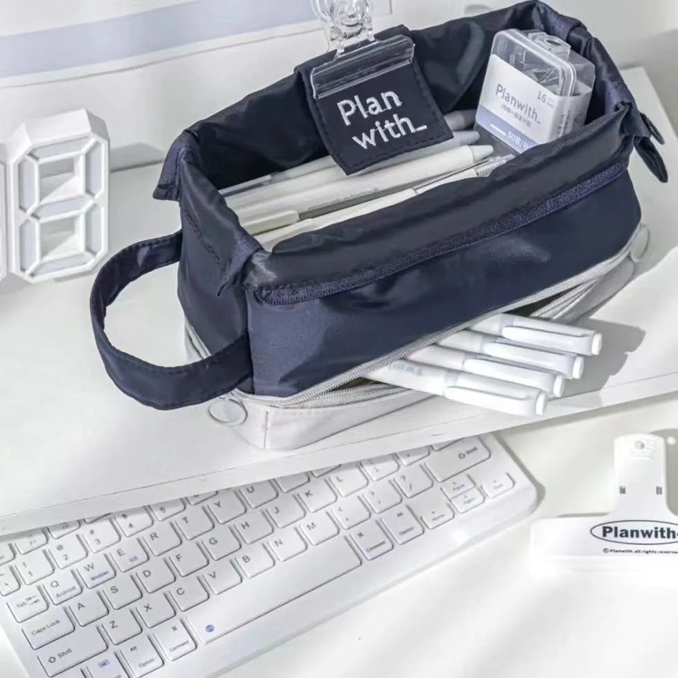 Dark blue double layer folding fabric pencil case open to show A4 layout with elastic pen slots.