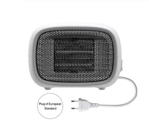 Green, white and yellow mini personal space heater on a desk showing compact size.