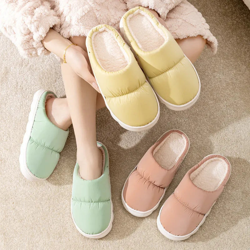 Pair of thick-soled winter slippers with artificial leather upper and plush lining, shown in a choice of colours.