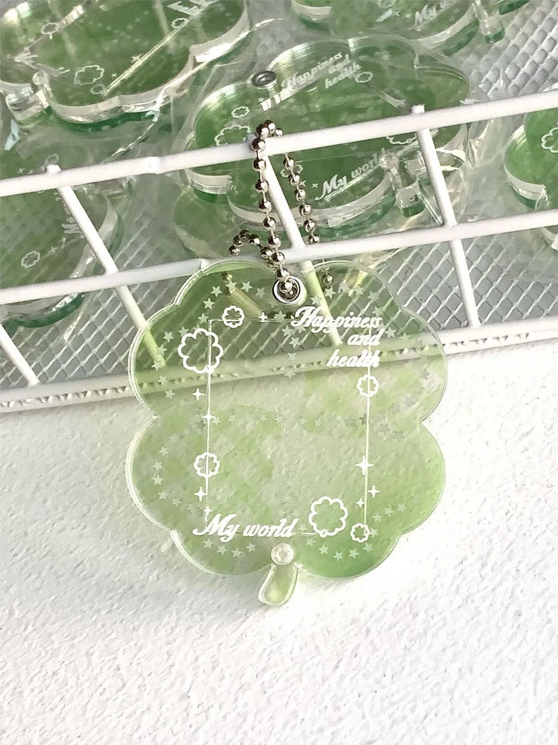 Acrylic four-leaf clover shape keychain pendant for phones in blue, green, or mint.