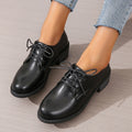 Black women's low-top shoes with a chunky thick heel and rubber sole.
