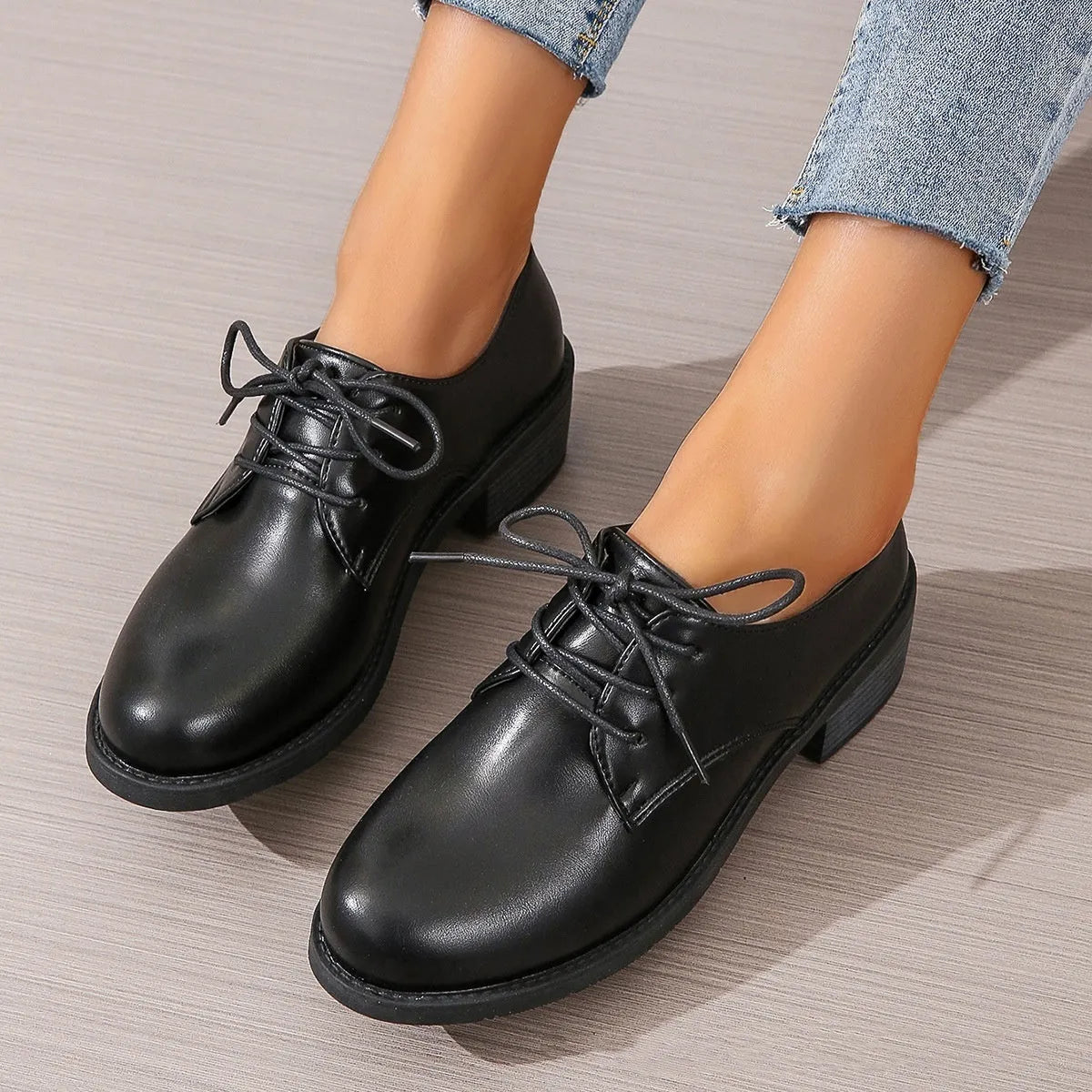 Black women's low-top shoes with a chunky thick heel and rubber sole.