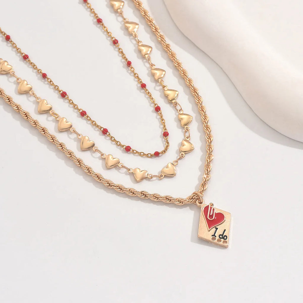Geometric three-layer heart pendant necklace on a model, showing adjustable clavicle chain length.