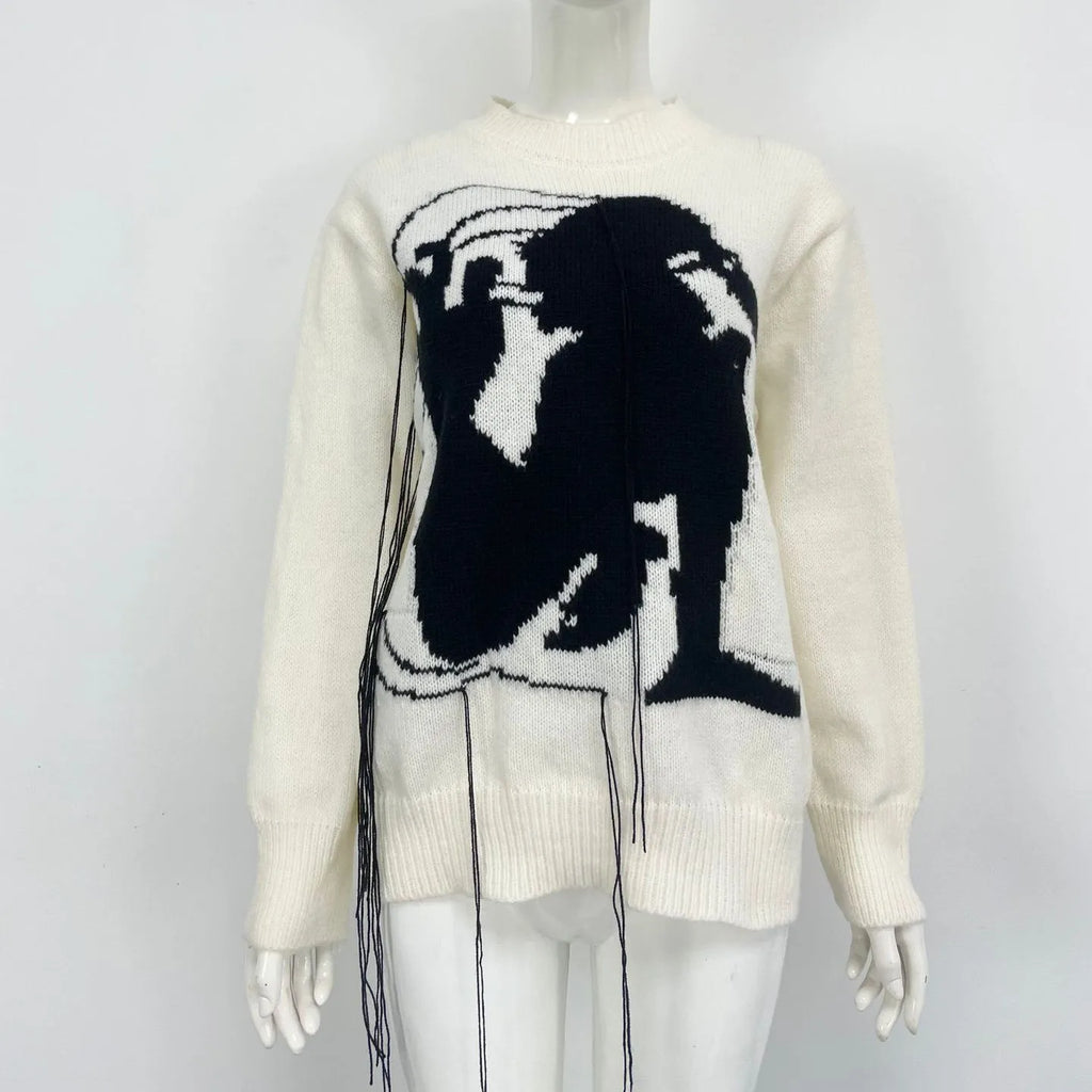 Grey alpaca wool women's sweater with abstract pattern and tassel detail on sleeve.