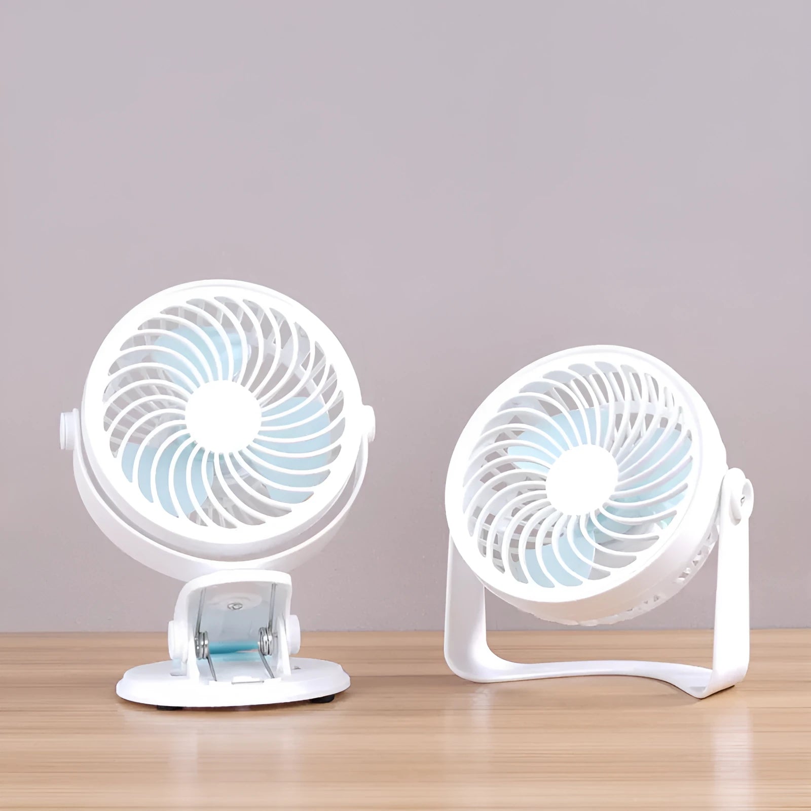 White USB desk fan with clip attachment and three blades, shown on a desk.