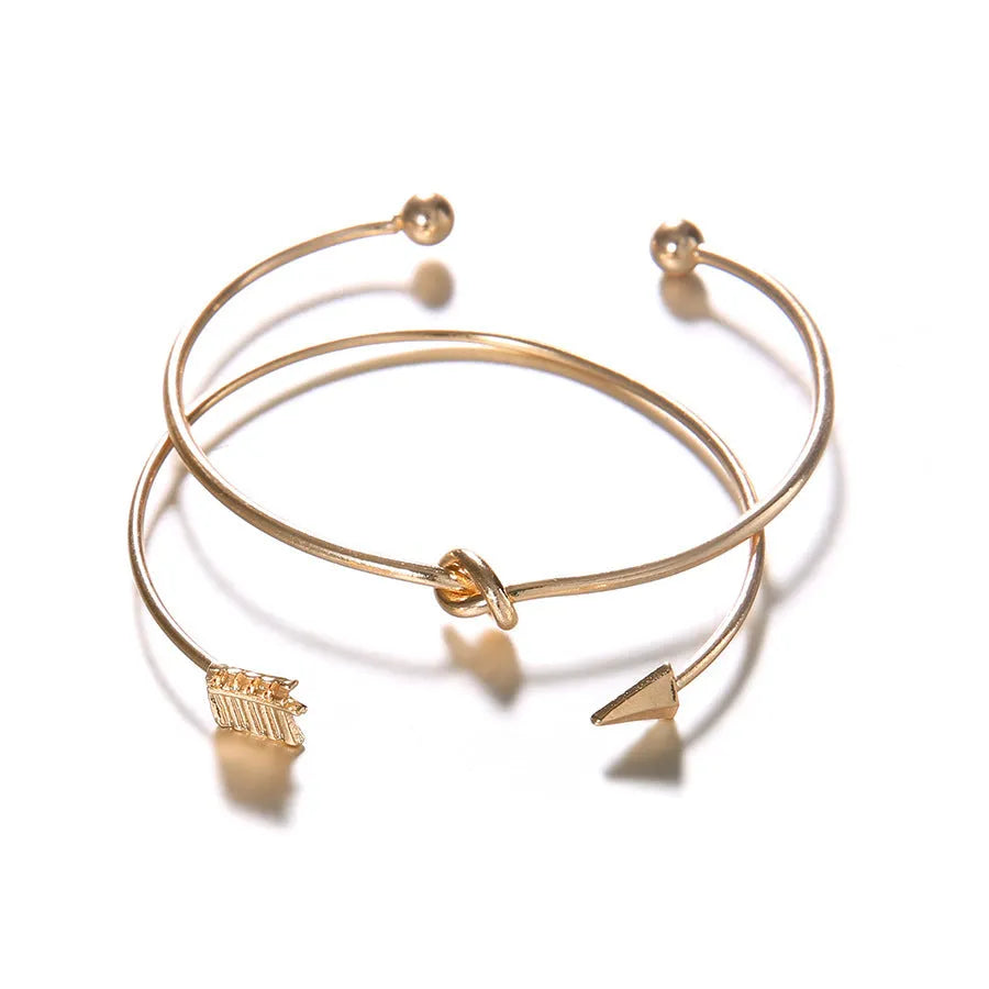 Women's vintage gold arrow knotted cuff bracelet made from electroplated alloy.