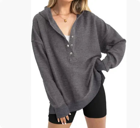 Women's loose peacock green raglan sleeve pullover sweater on a hanger.