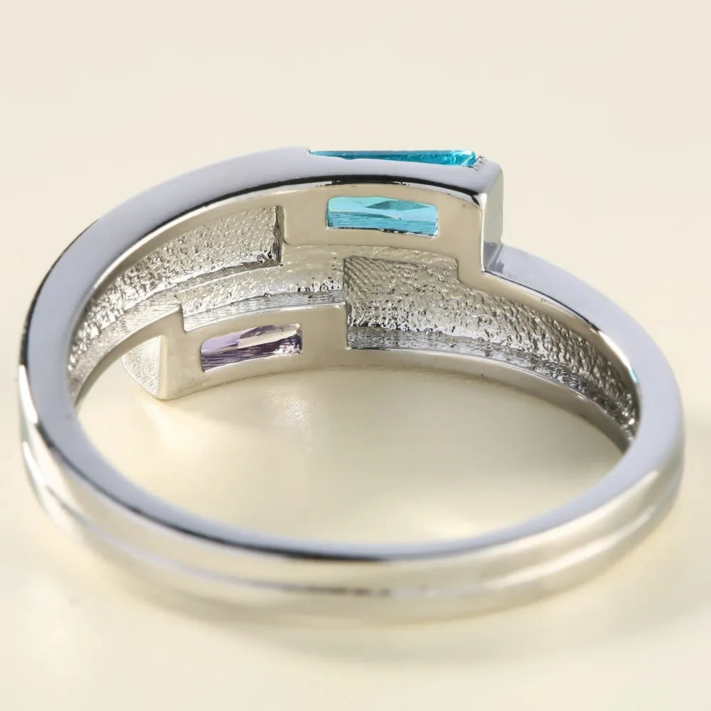 Copper ring with silver electroplated finish and inset zircon detail on a finger.