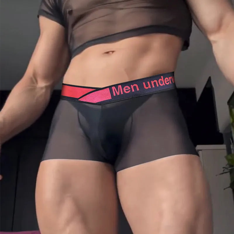 Men's black low waist seamless underwear with a red gradient laser print design on the front