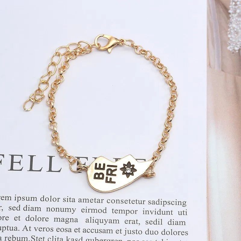Heart shape alloy bracelet with dripping oil finish and inlaid gems in gold and silver colours