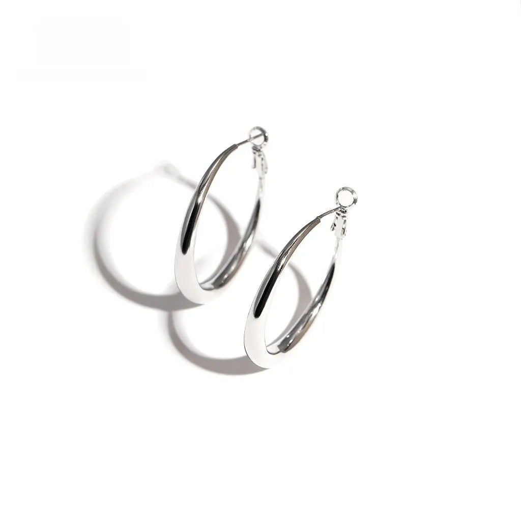 Silver needle big circle bracelet and earrings set with electroplated platinum finish on light background, three size options