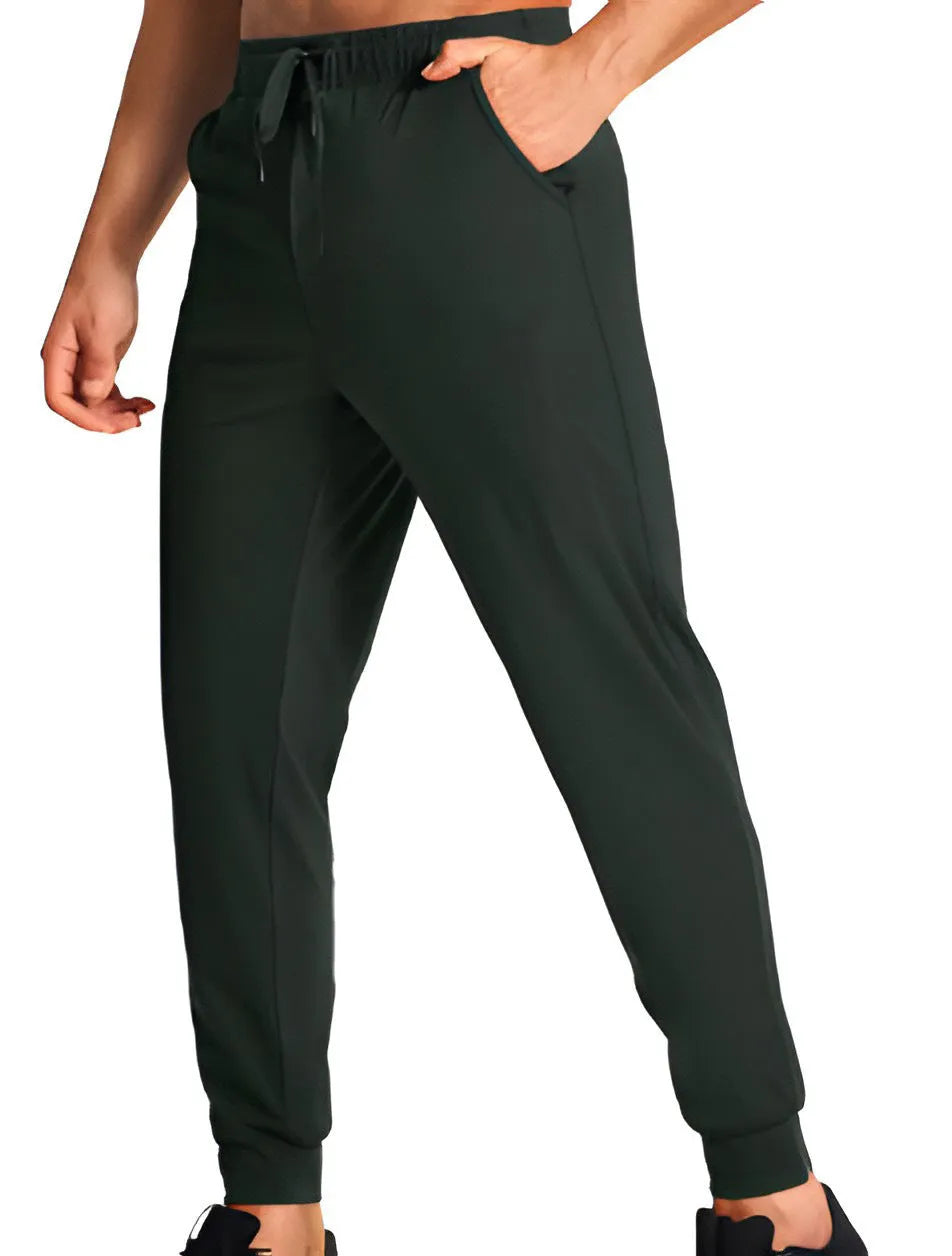 Men's loose-fitting casual polyester trousers in a solid colour on a hanger.