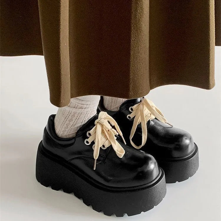 Women's matte black lace-up shoes with a chunky 6-8cm heel and thick rubber sole.