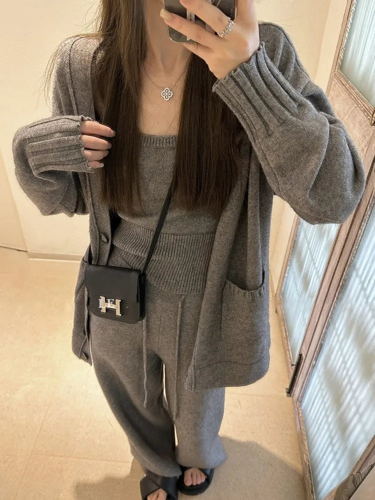 Women's knit three-piece set showing cardigan coat, vest, and suspender trousers in beige colour