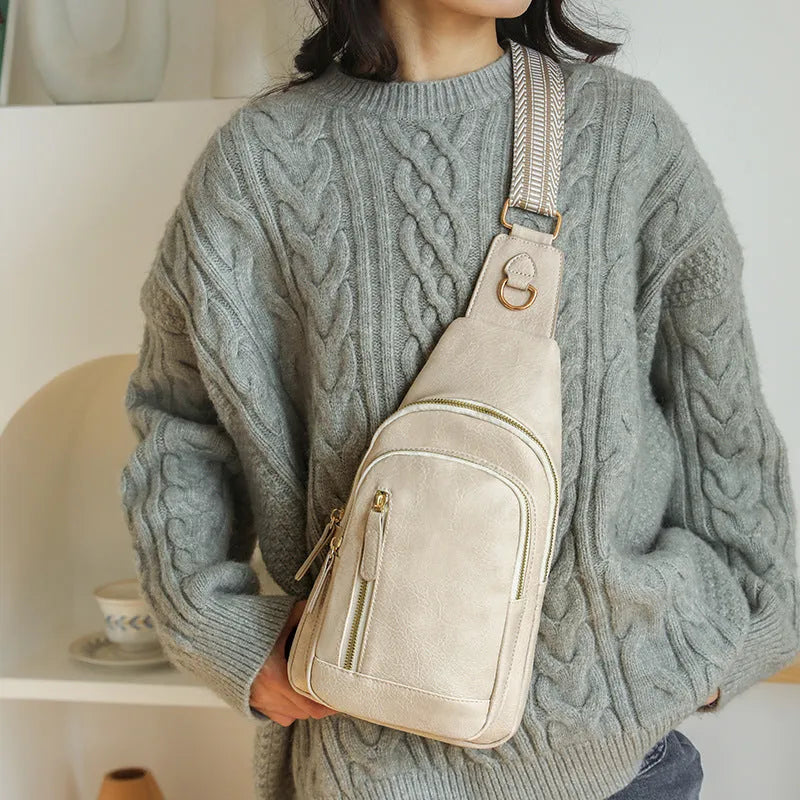Soft brown women's crossbody chest bag showing zip compartments and street-style sewing thread detail