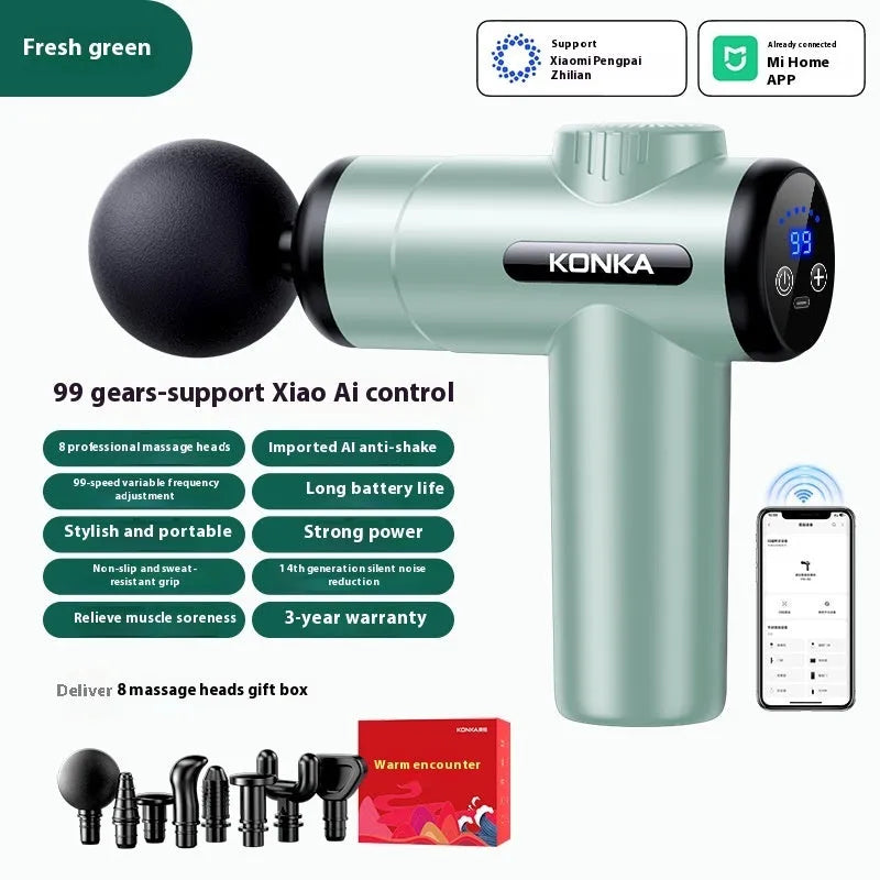 Konka V19 grey mini electric massage gun with multiple attachment heads on a table