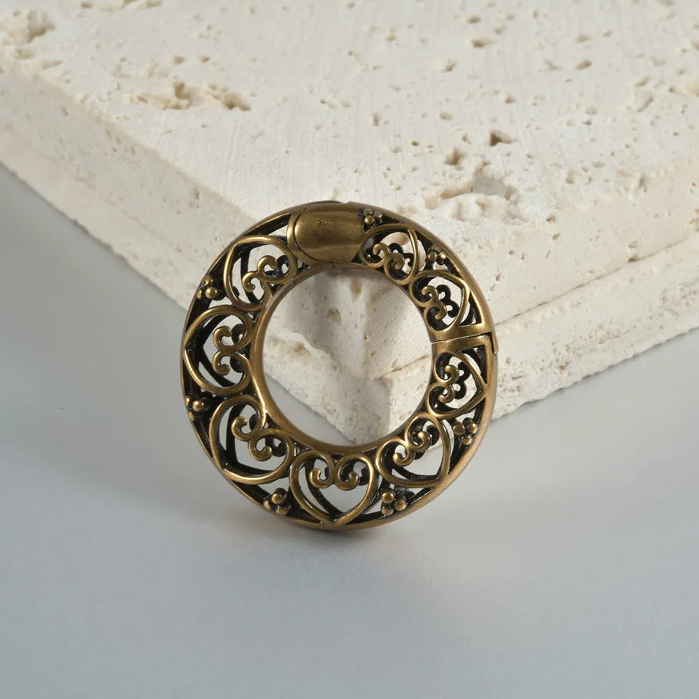 Retro heart-shaped hollow lotus magnetic earrings in stainless steel with antique finishes