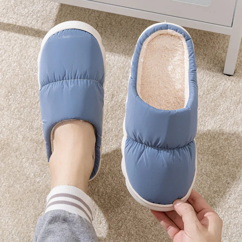 Pair of thick-soled winter slippers with artificial leather upper and plush lining, shown in a choice of colours.