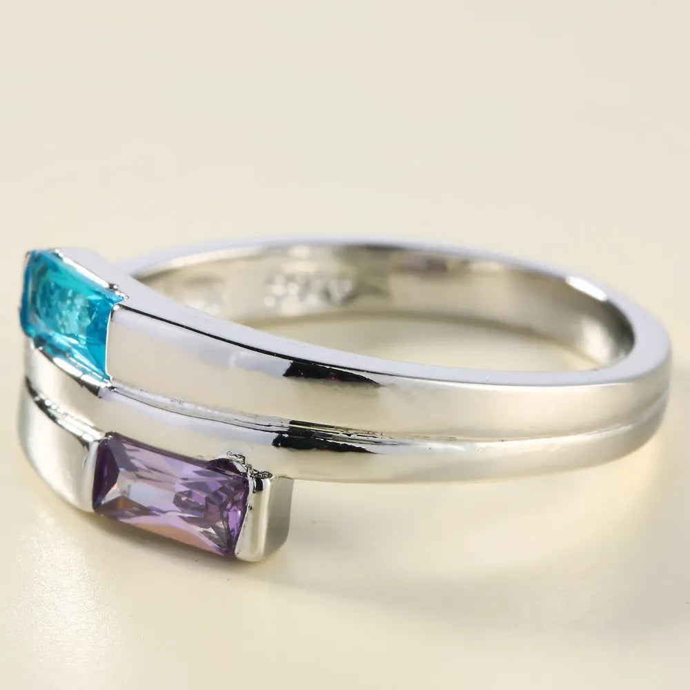 Copper ring with silver electroplated finish and inset zircon detail on a finger.