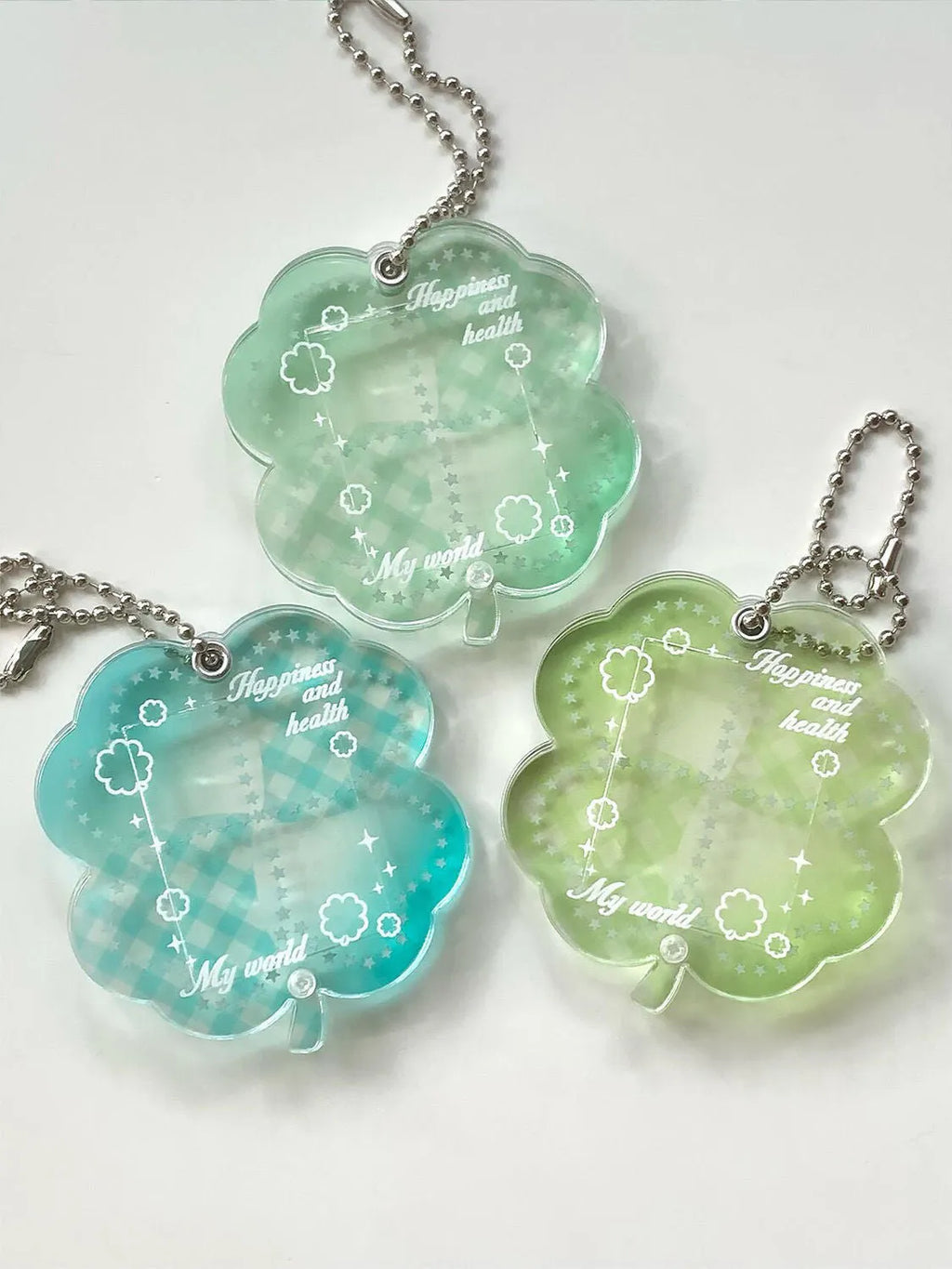 Acrylic four-leaf clover shape keychain pendant for phones in blue, green, or mint.