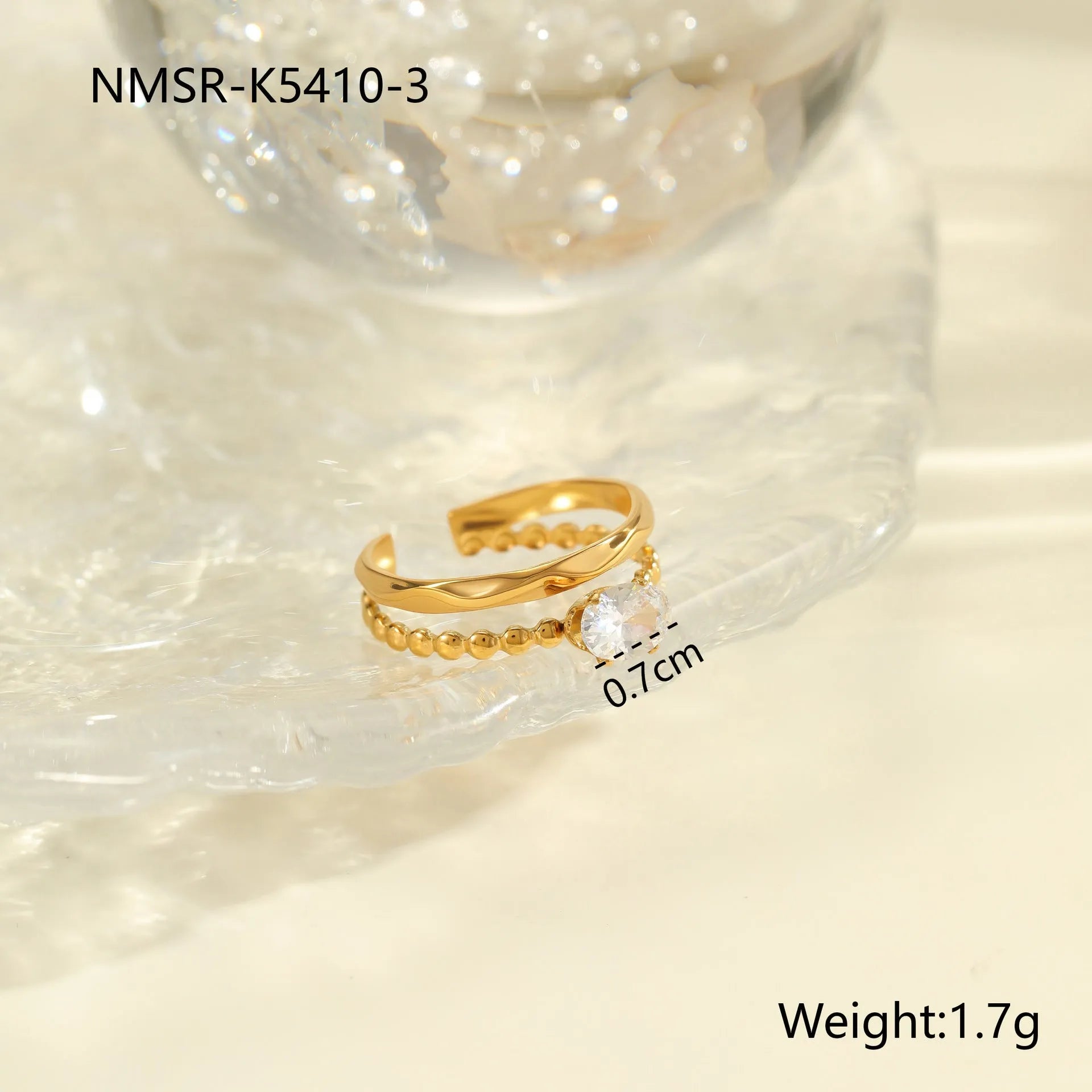 Gold-plated geometric stainless steel ring with inlaid zircon stones on a white background.