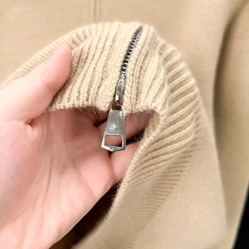 Men's black zip-up knitted cardigan with a stand collar on a hanger